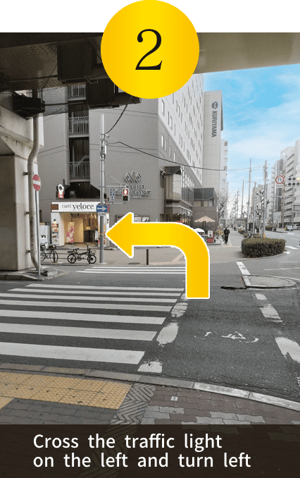 Cross the traffic light on the left and turn left
